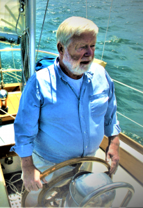 Older man sailing a boat