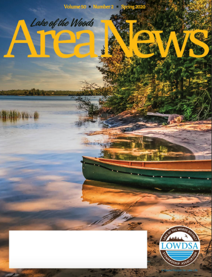 Magazine cover with green canoe on shore