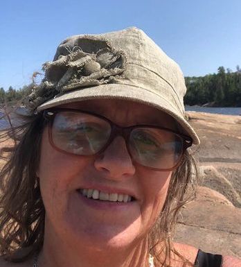 Woman in hat looking at camera