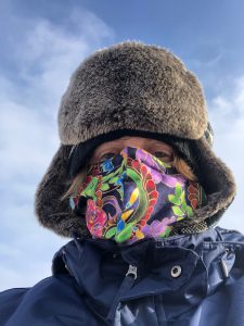 woman in a fur hat and face mask