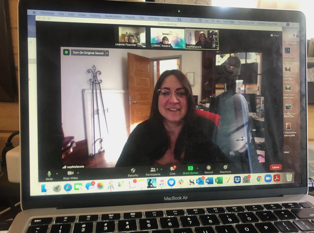 Woman speaking on screen surrounded by art supplies