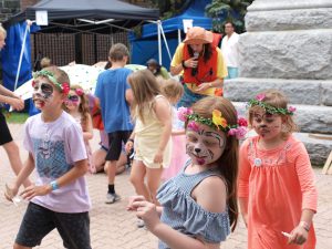 Children dancing in flowered headbands