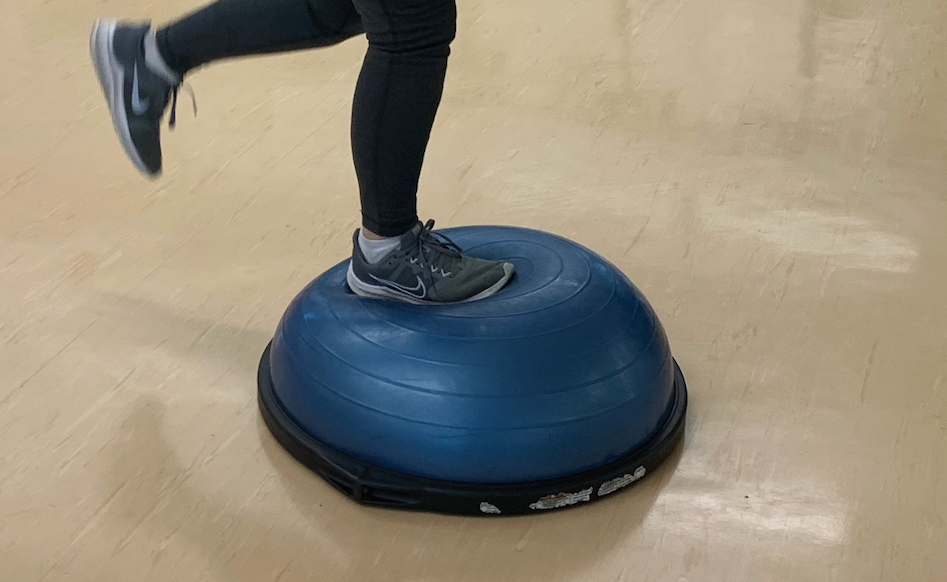 foot in running shoes on a bosu ball