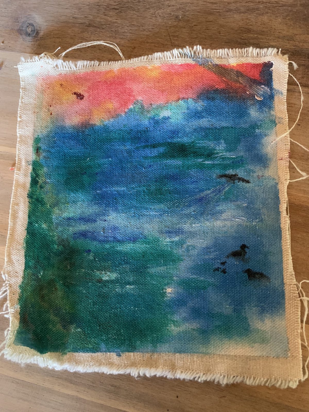 Coloured abstract picture on a woven background.